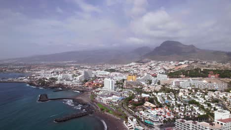 Aerial-flying-backwards-of-Tenerife-coast-holiday-resort-city