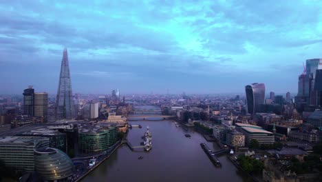 Aerial-View-Of-Famous-London-Skyline-Along-River-Thames-In-Blue-Late-Afternoon