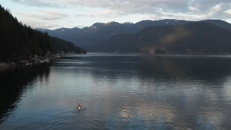 Aerial-view-of-person-paddling-kayak-in-Deep-Cove,-a-community-in-north-Vancouver,-British-Columbia