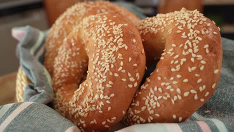 Freshly-Baked-Round-Bagels-with-Sesame-Seeds-on-Towel-in-Close-Up