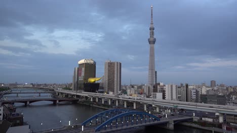 High-above-time-lapse-at-Sumidagawa-in-Tokyo,-Japan-with-Skytree-in-distance