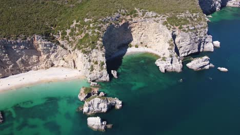 AERIAL-An-Orbiting-Shot-of-Crescent-Shaped-Beach-in-Portugal