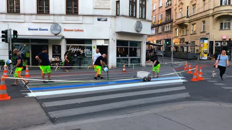 PRIDE-MONTH---Painting-crosswalk-in-LGBTQ-Rainbow-Flag-colors,-Vienna,-Austria