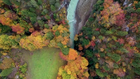 Aerial-Flight-Over-Mist-Forrest-Colorful-Autumn-Trees-and-Beautiful-blue-canyon-river-in-autumn-forest,-top-view