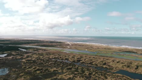 Scenic-Road-In-The-Middle-Of-Salt-Marshes-Near-Texel-National-Park-At-Waddensea-Island-In-North-Holland,-Netherlands