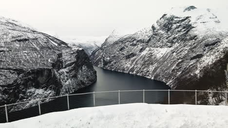 Aerial-View-Of-Snowy-Lookout-Point-Of-Ornesvingen-And-Geiranger-Fjord-In-Norway