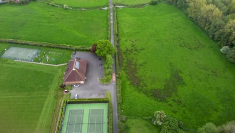 Aerial-video-flying-over-a-tennis-court-and-local-sport-centre