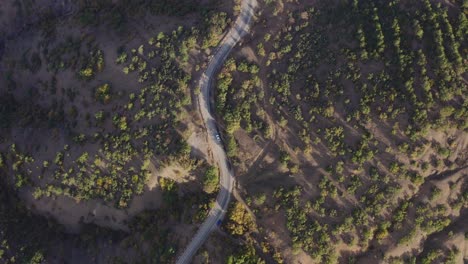 Aerial-view-of-a-car-driving-on-the-beautiful-road-in-the-mountians