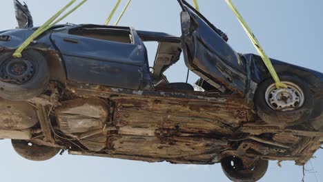 Air-lifting-a-wrecked-accident-scrapyard-car-from-landfill
