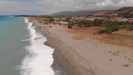 Aerial-view-of-beach-in-Catanzaro-region-in-Calabria,-Italy-during-a-cloudy-stormy-day