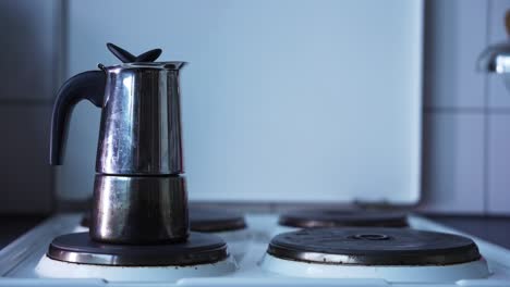 Shiny-and-reflecting-coffe-machine-that-is-brewing-coffe,-standing-on-a-old-school-white-stove
