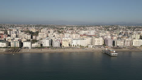 Aerial-retreats-from-Durres-Albania-beach-restaurant-pier-waterfront