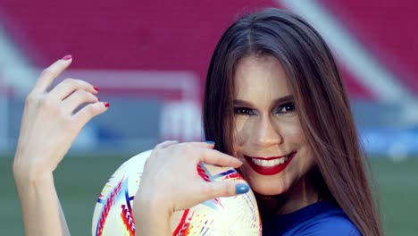 Cute-Brazilian-brunette-smiles-and-plays-with-football