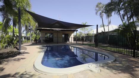 Fenced-Pool-in-Backyard-with-shade-cloth-on-sunny-day