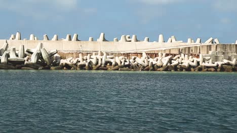 Harbour-wall-with-dolos-coastal-management,-sea-wall-defense