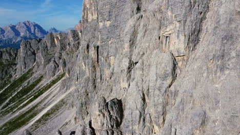 aerial-orbit-of-sharp-rocks-along-Dolomites-mountain-ridge-on-a-sunny-summer-day