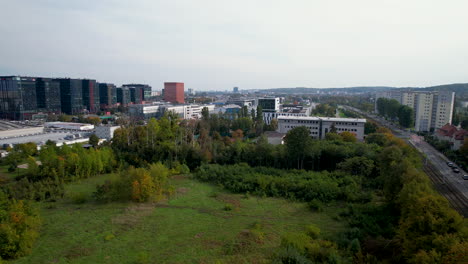 Flying-Over-Stadion-UG-With-Distant-View-Of-Business-Buildings-In-Oliwa,-Gdansk,-Poland