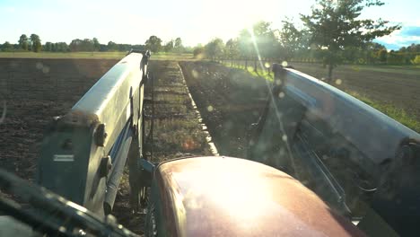 POV-Through-Windshield-Of-An-Agricultural-Tractor-Cabin-Plowing-Field-On-A-Sunny-Day