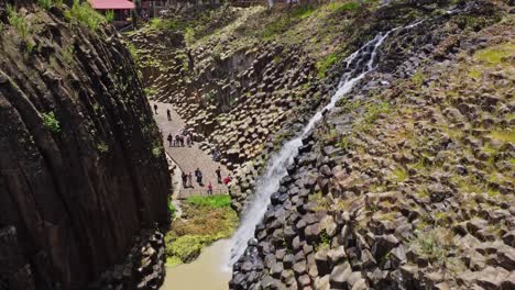Aerial-drone-shot-of-prism-rocks-and-a-waterfall