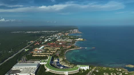 Aerial-view-over-hotels-on-the-coastline-of-Xpu-Ha,-Mayan-Riviera,-Mexico---pull-back,-drone-shot