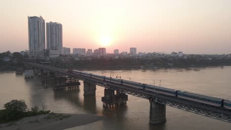Train-running-on-the-bridge-over-the-river-in-the-morning-dawn