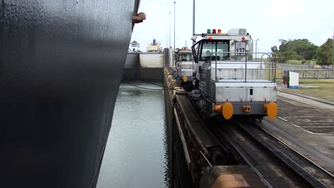 Locomotives-slowly-pulling-the-cruise-ship-in-the-chamber-at-Gatun-locks,-Panama-Canal