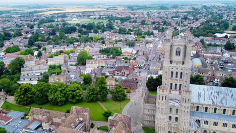 Aerial:-Ely-Cathedral-church-gate-top-view-with-urban-cityscape,-tracking-drone-shot