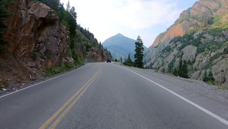 POV-while-driving-on-Million-Dollar-Highway-with-dramatic-views-Uncompahgre-River-Gorge-and-San-Juan-Mountains-near-Ouray-Colorado