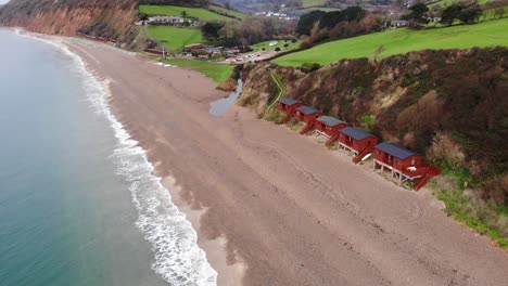 Amazing-4K-Aerial-zoom-towards-the-shoreline-above-the-rolling-waves-of-UK's-Branscombe-beach
