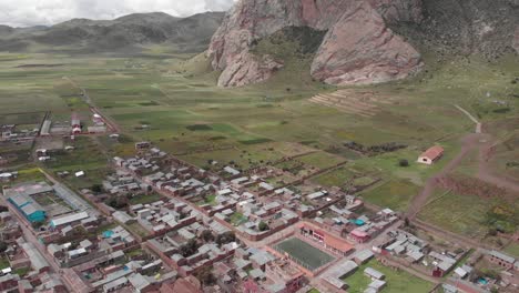 Aerial-flyover-of-St-Isabel-Church-to-farms-outside-Pucara,-Peru