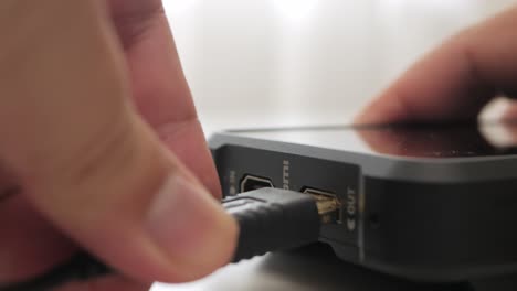 Inserting-HDMI-cable-into-the-side-port-of-external-monitor-closeup