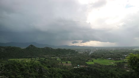 Scenic-viewpoint-of-landscape-with-green-vegetation-and-hilltops-during-a-rainstorm-approaching-over-the-land-in-Thailand