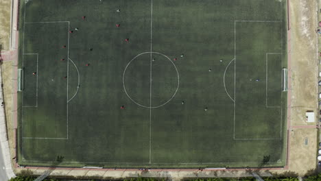 Locals-get-together-for-a-Sunday-afternoon-soccer-match-in-Manzanares-Spain---Aerial-birds-eye-footage-of-the-game-in-progress
