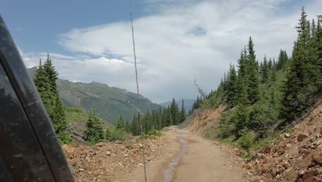 POV-while-driving-a-off-road-vehicle-on-a-narrow-portion-of-Alpine-Loop-trail-through-the-San-Juan-mountains-near-Silverton-Colorado