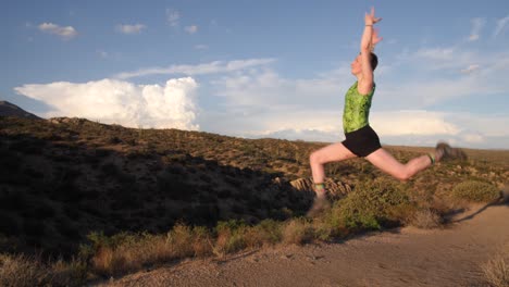 Gymnast-jumps-into-the-air-posing-with-her-arms-over-her-head