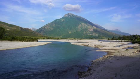 Panoramic-river-landscape-with-beautiful-mountain-and-cloudy-sky-background-in-Albania