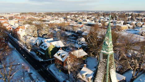 AERIAL-Flyby-Close-Up-Of-Old-Church-Spire-In-Winter-Snow