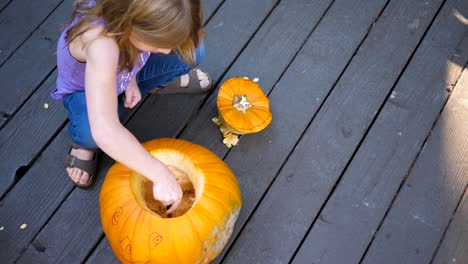 Cute-kid-carving-halloween-pumpkins