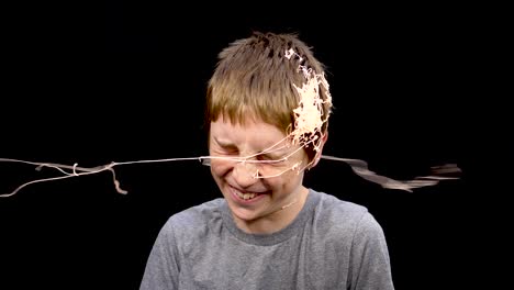 Slow-motion-of-boy-getting-hit-with-spray-string