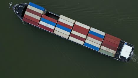 Aerial-Top-Down-View-Of-Cargo-Containers-Being-Transported-On-River