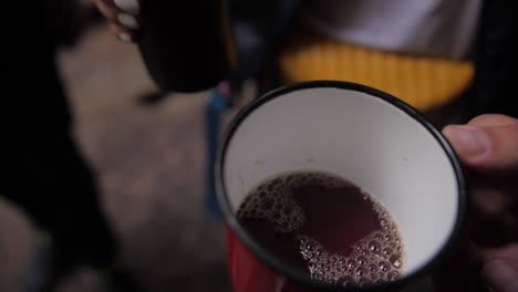 Tea-pouring-from-thermos-to-the-red-cup-slow-motion