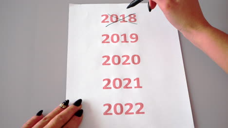 Crossing-out-the-years,-marking-the-upcoming-next-new-year-2020