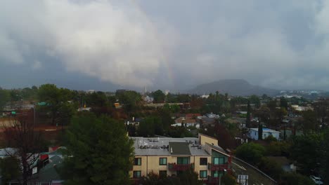 4K-Aerial-Drone-footage-of-Studio-City,-CA-with-rain,-cloudy-skies-and-a-rainbow