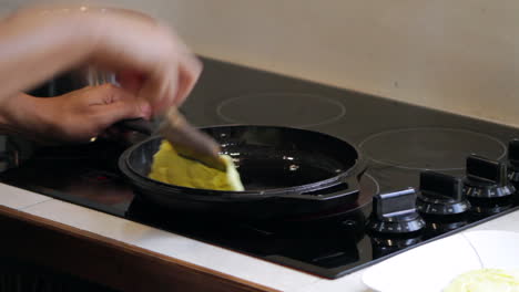 Man-cooks-and-flips-food-in-cast-iron-skillet