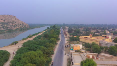 A-drone-view-with-the-canal-and-hill-of-the-village-of-Sindh,-Pakistan