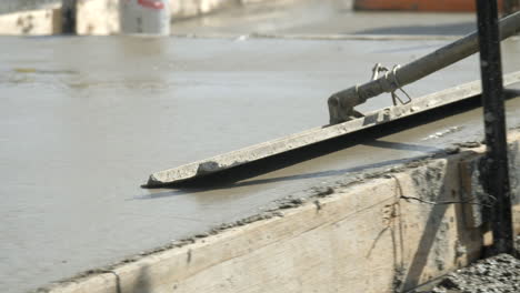 CLOSE-UP-Cement-Float-Over-Wet-Concrete-At-Newly-Laid-House-Slab-SLOW-MOTION