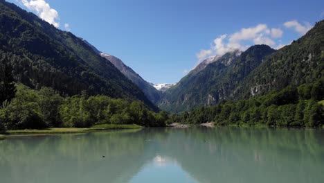 Klammsee-Kaprun-With-Reflections-Of-Mountains-And-Trees-Around-In-Austria---aerial-shot