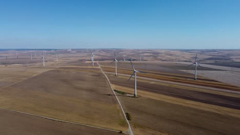 Wind-farm-on-massive-stretch-of-open-land,-drone-view