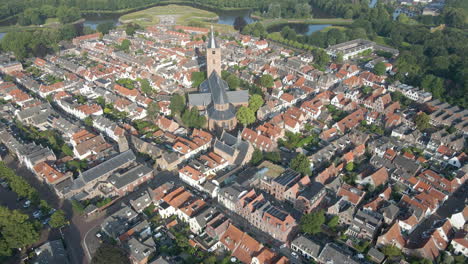 Aerial-view-of-large,-classic-church-located-in-a-small-town-center