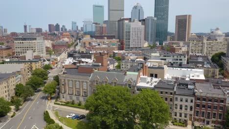 Low-Aerial-Establishing-Shot-of-Apartment-Buildings-in-Boston,-Skyline-in-Background